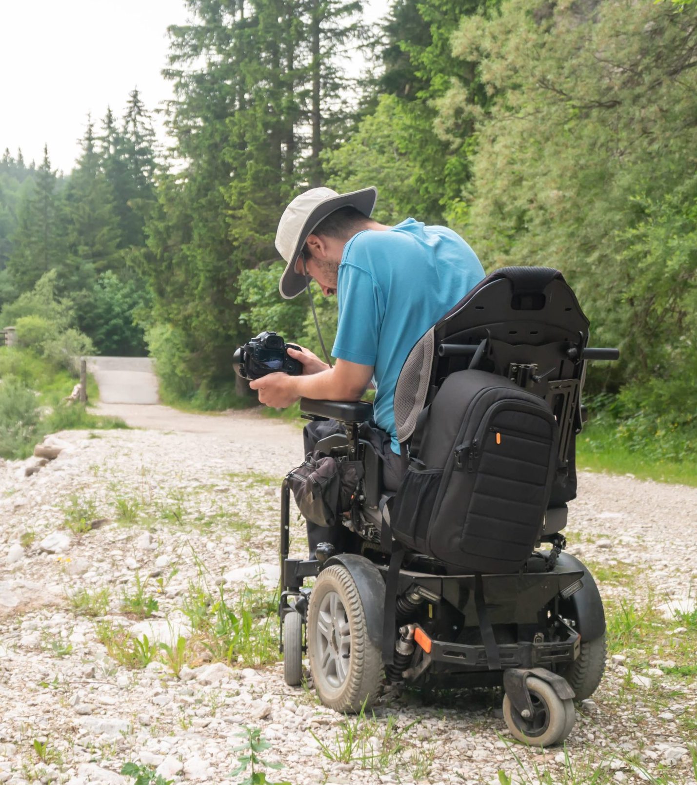 photographer in powerchair taking a picture of a bridge