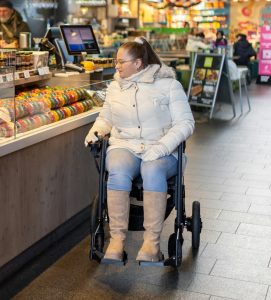 Woman in a wheelchair shopping independently